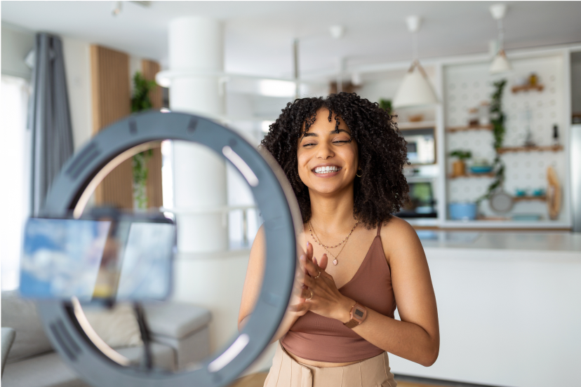 Woman smiling and looking into a smartphone camera