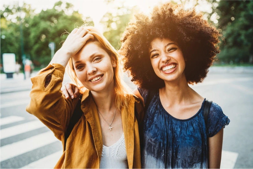 Two women standing side by side smiling