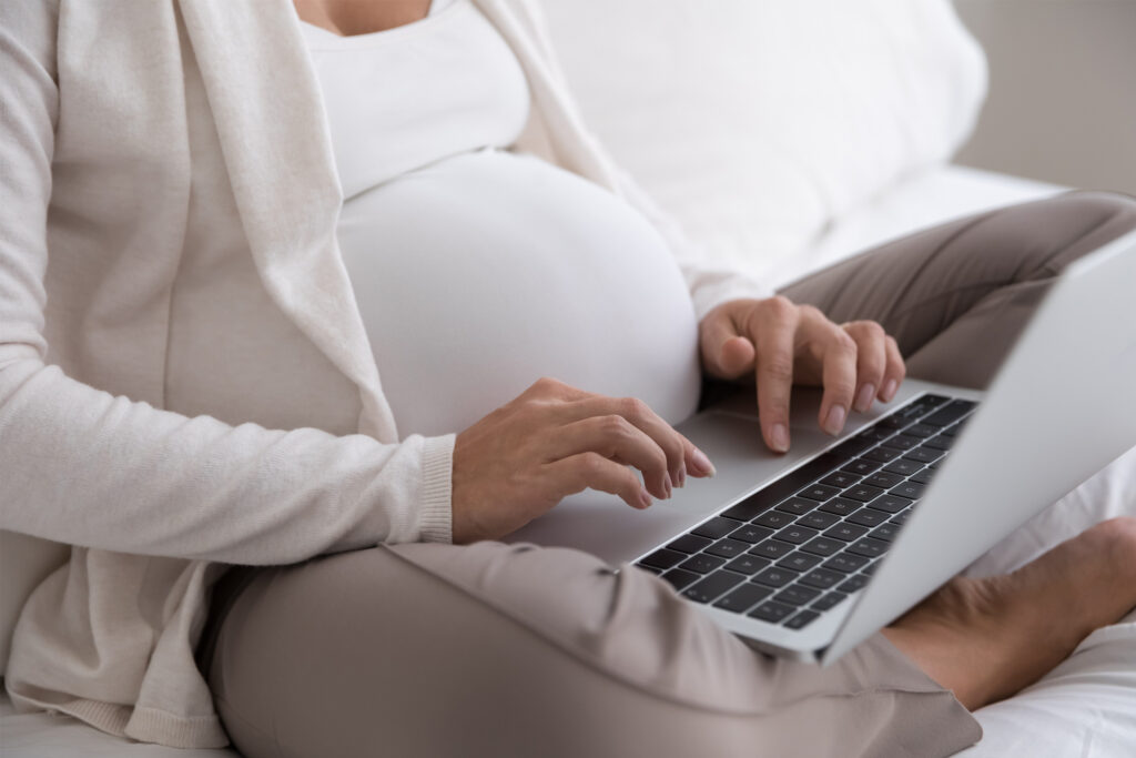 Pregnant woman on laptop